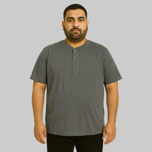 Plus-size Pakistani male model wearing steel short-sleeve Henley shirt on a clean studio background, relaxed fit.