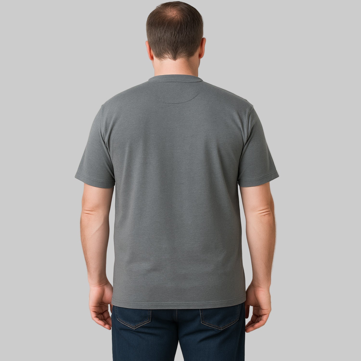 Plus-size Pakistani male model wearing steel short-sleeve Henley shirt on a clean studio background, relaxed fit.