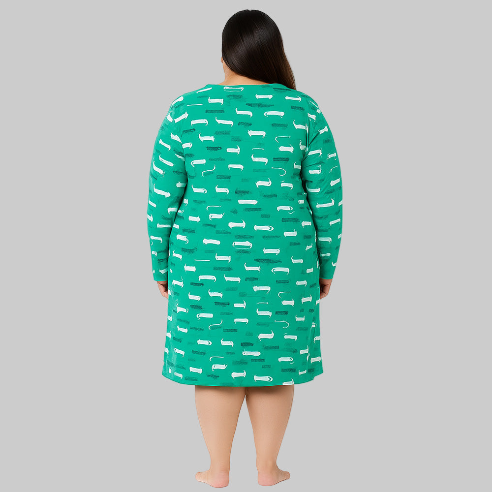 Plus-size woman wearing a tidal green printed long sleeve cotton sleepshirt, knee length, comfortable fit.