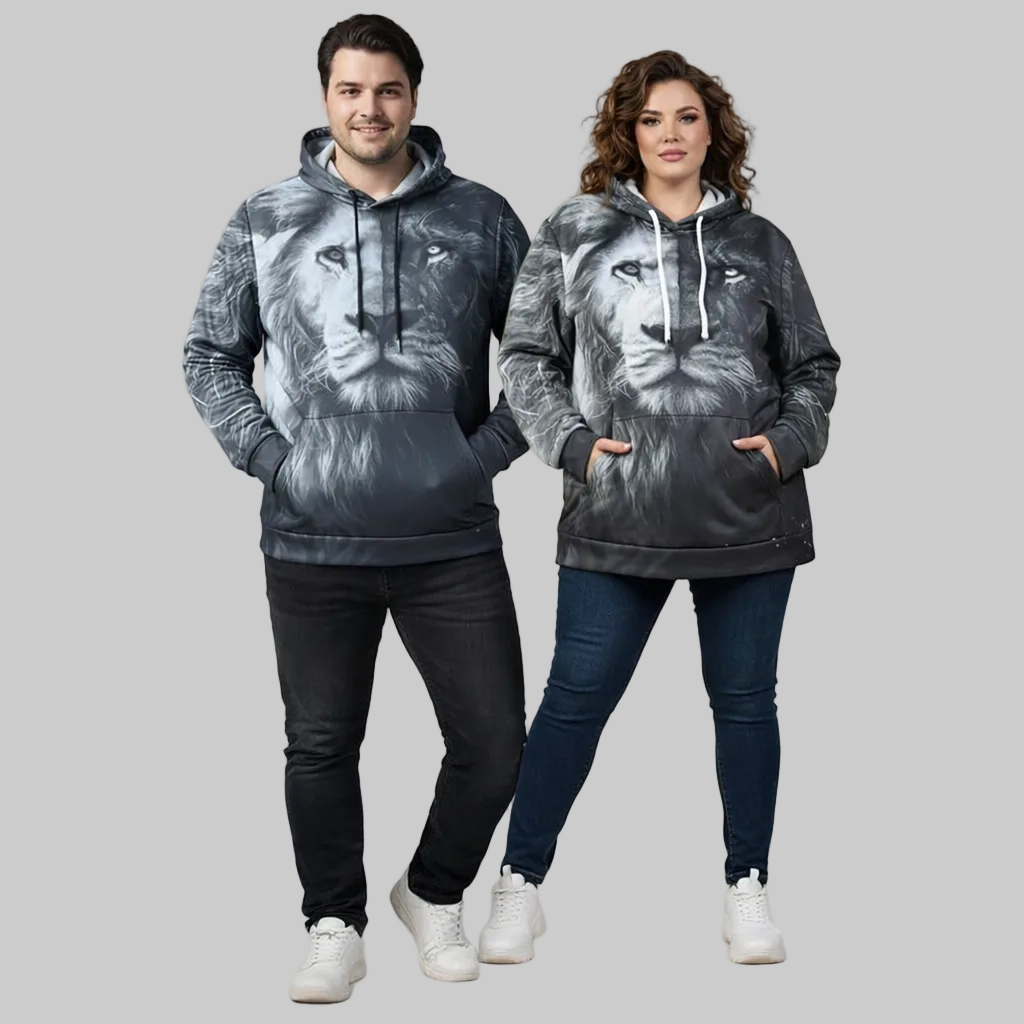 Plus-size male and female models wearing black “Midnight Strength” graphic hoodies with front print, styled in a cozy modern studio setup.