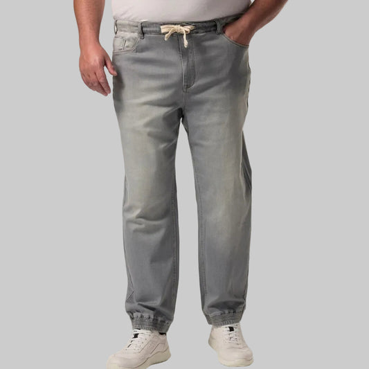 Urban Ash Comfort Denim Joggers Jeans in a dark ash-grey wash, featuring a relaxed jogger fit with tapered legs, soft stretch denim fabric, elastic waistband with drawstring, ribbed cuffs, side pockets, and a modern casual streetwear look