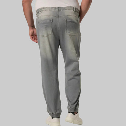 UrbanAsh Comfort Denim Joggers Jeans in a dark ash-grey wash, featuring a relaxed jogger fit with tapered legs, soft stretch denim fabric, elastic waistband with drawstring, ribbed cuffs, side pockets, and a modern casual streetwear look