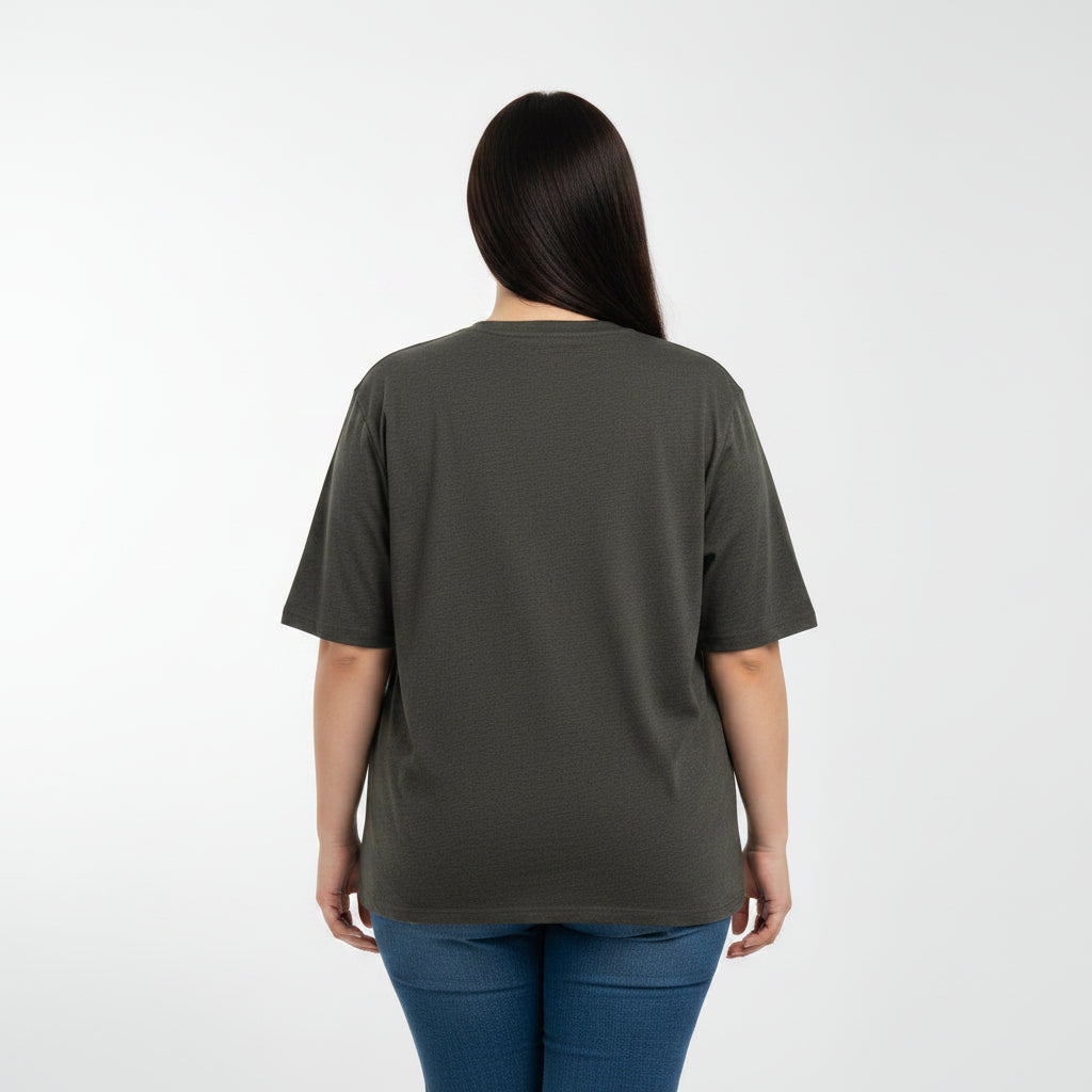 Woman wearing a dark green t-shirt and blue jeans on a white background