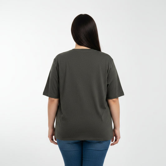 Woman wearing a dark green t-shirt and blue jeans on a white background