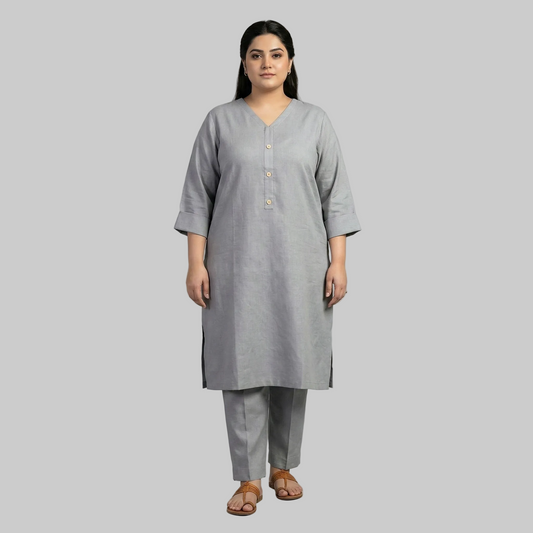 Woman wearing a gray kurta with pants on a gray background