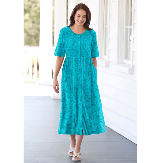 Woman wearing soft blue floral button-front dress with elbow sleeves and flowing skirt

