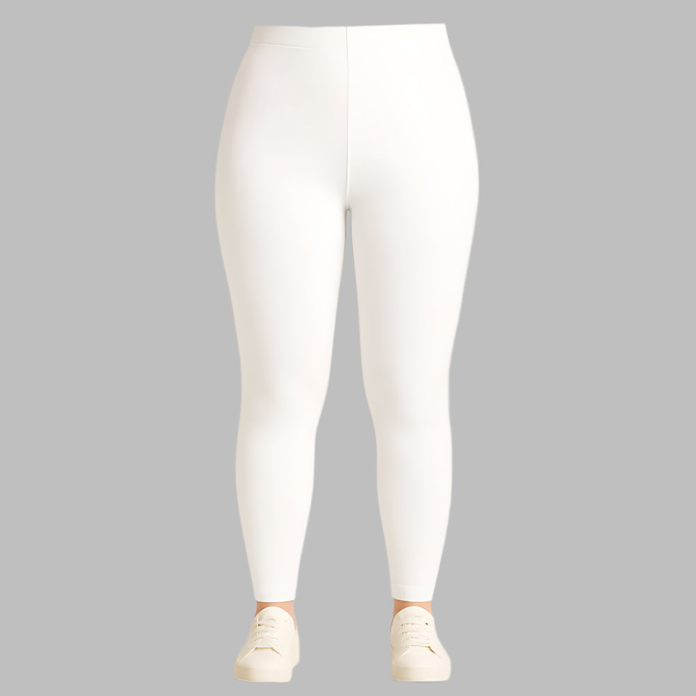 Plus size woman wearing high-rise white performance activewear leggings in studio