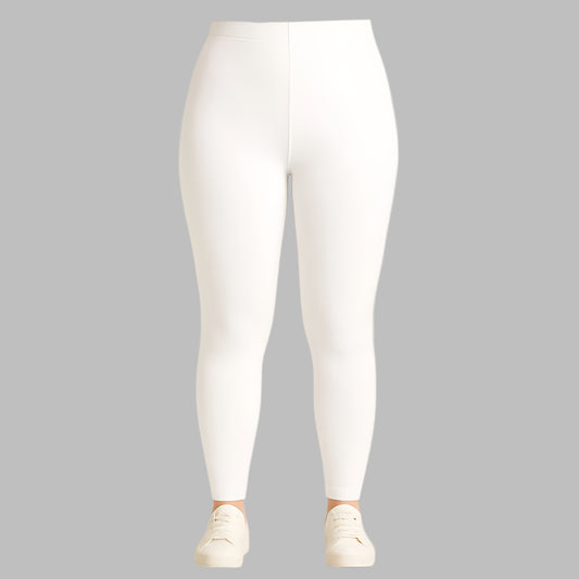 Plus size woman wearing high-rise white performance activewear leggings in studio