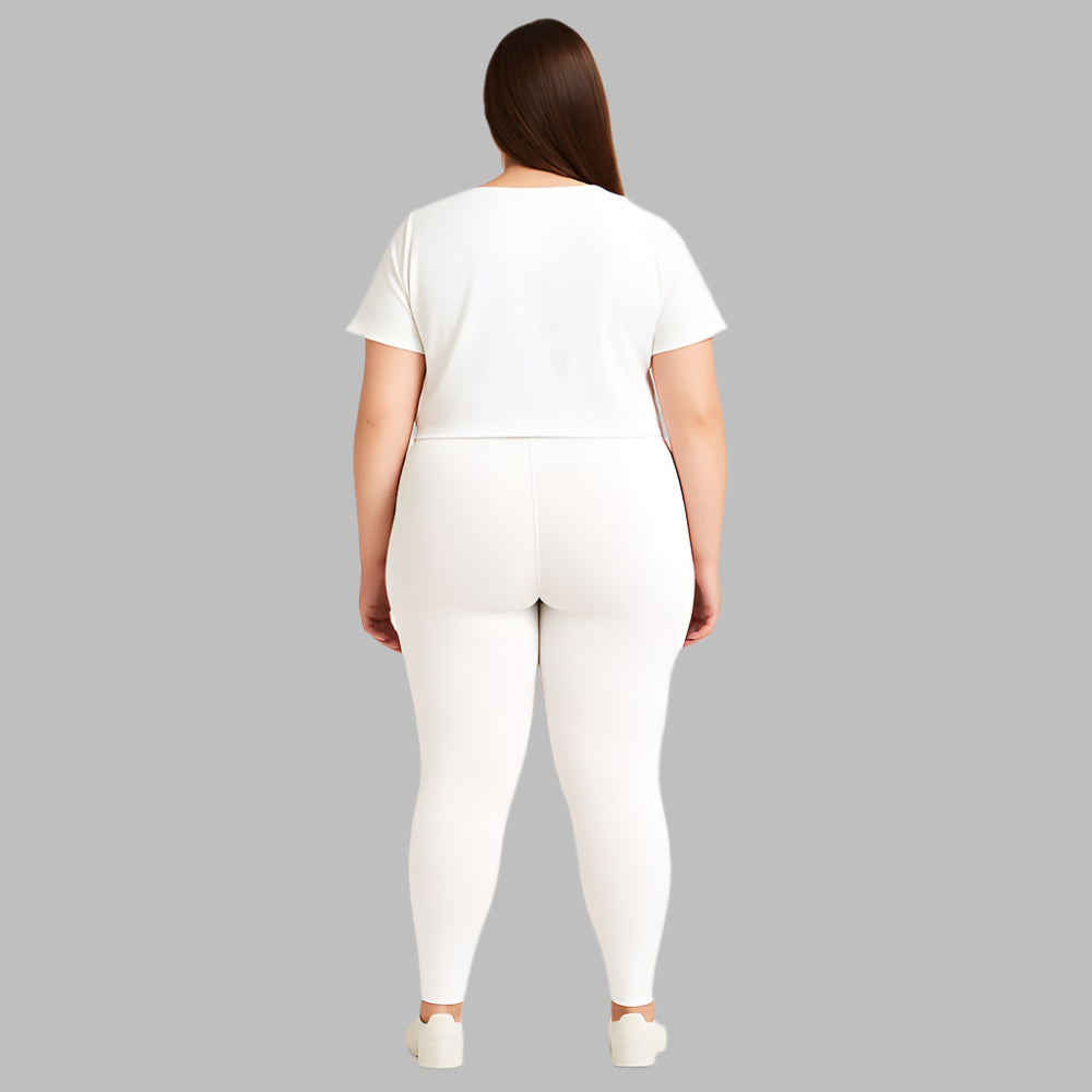 Plus size woman wearing high-rise white performance activewear leggings in studio