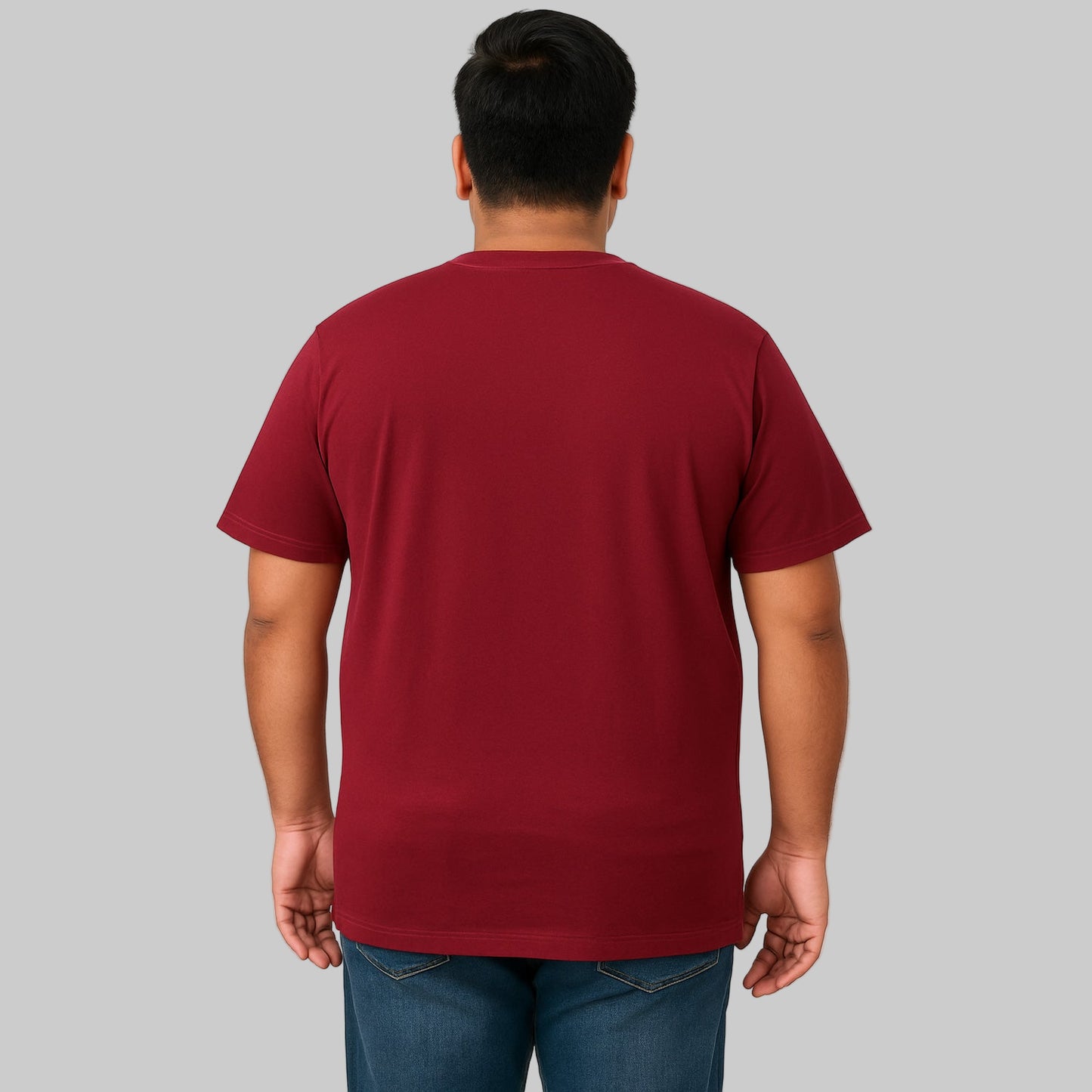 Plus-size male model wearing wine-colored crewneck pocket T-shirt, relaxed fit, front view, studio background.