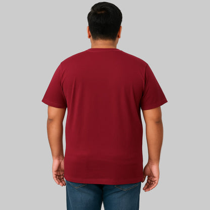 Plus-size male model wearing wine-colored crewneck pocket T-shirt, relaxed fit, front view, studio background.