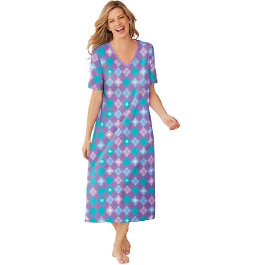 Woman wearing lilac and teal winter-themed plaid sleepshirt with snowflake print
