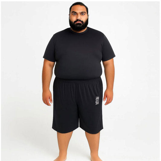 Man wearing black Dri-Fit knit shorts with relaxed fit and elastic waistband