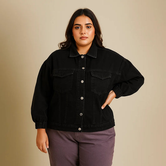 Plus-size woman wearing black denim jacket with flap pockets and button closure

