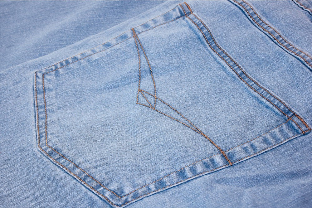 Men’s Light Wash Stretch Fit Denim Jeans with straight-leg cut, YKK zip fly, button fastening, and stretch cotton blend for comfort.