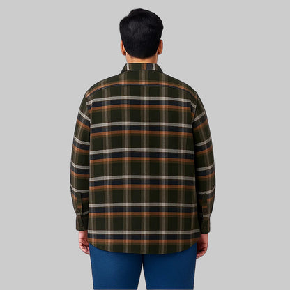 Plus-size man wearing a forest green plaid fleece-lined flannel shirt jacket with button front, flap chest pockets, and side seam pockets on a white studio background.