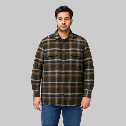 Plus-size man wearing a forest green plaid fleece-lined flannel shirt jacket with button front, flap chest pockets, and side seam pockets on a white studio background.